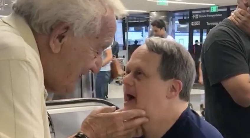 hugs father at airport